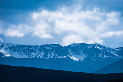 Scenic view of snowcapped mountains against sky