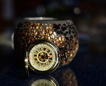 Close-up of pocket watch on table