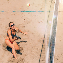 Beach tennis player hits the ball