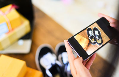 High angle view of person using smart phone on table