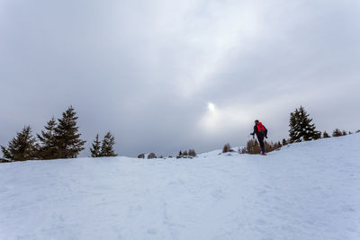 Scenic view of snow covered field against sky