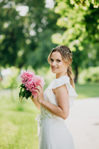 Portrait of a smiling young woman against blue sky