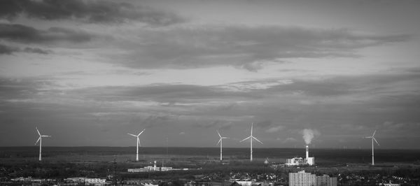 Traditional windmill by windmills against sky