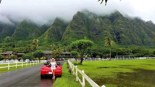 People sitting on mountain road against trees