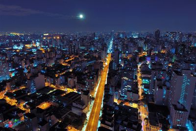 High angle view of illuminated city buildings at night