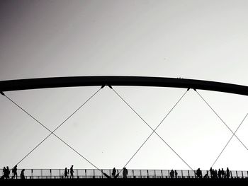Low angle view of suspension bridge against clear sky