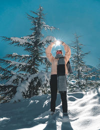 Woman standing on snow covered field