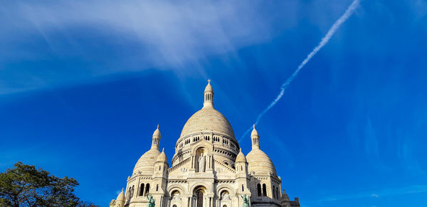 Low angle view of building against blue sky