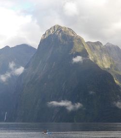 Scenic view of sea and mountains against sky