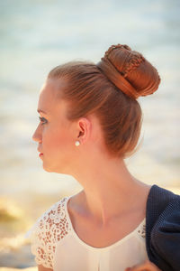 Close-up of young woman looking away