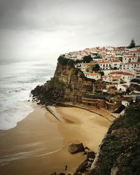 High angle view of houses on cliff by sea at azenhas do mar