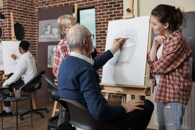 Side view of business colleagues working in meeting