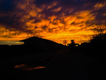 Silhouette of built structure against dramatic sky