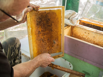 Midsection of woman holding honey
