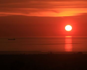 Scenic view of sea against orange sky