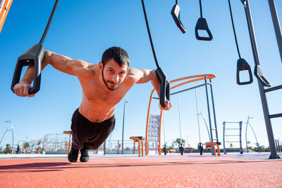 Full length of young man jumping in park