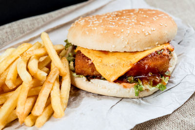 Close-up of burger with french fries on table