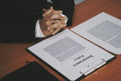 High angle view of man using mobile phone on table