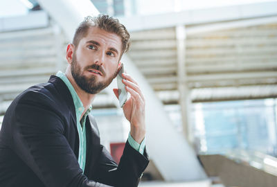 Portrait of young man sitting outdoors
