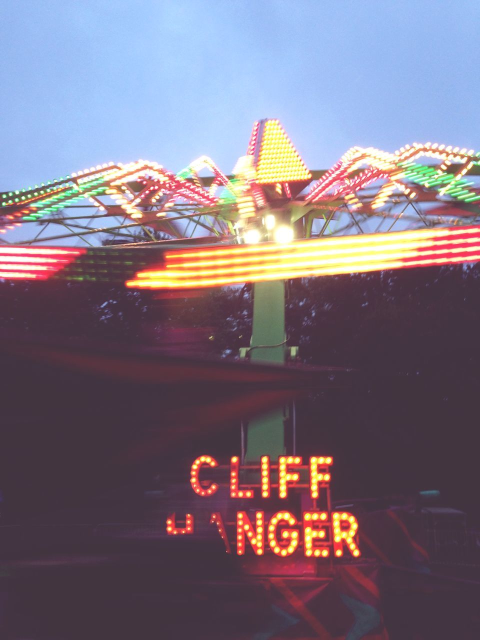 LOW ANGLE VIEW OF ILLUMINATED FERRIS WHEEL AGAINST SKY