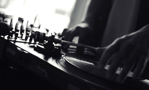 Close-up of hands on record player