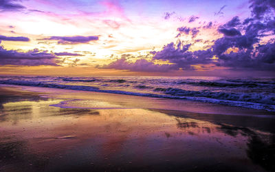 Scenic view of beach against dramatic sky