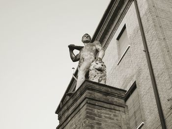 Low angle view of statue against building