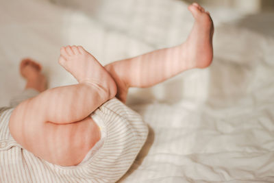 Close-up of baby hand on bed at home