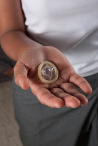 Midsection of woman holding condom