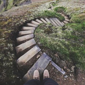 Low section of person standing on tiled floor