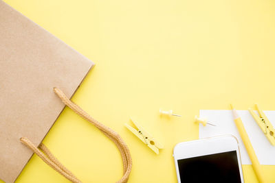 Close-up of yellow paper on table