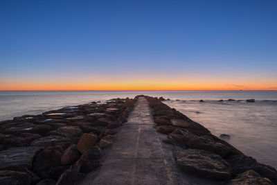 Scenic view of sea against clear sky during sunset