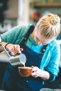 Close-up of man pouring coffee in cup