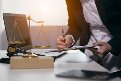 Midsection of woman holding umbrella