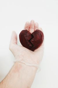 Close-up of cropped hand over white background