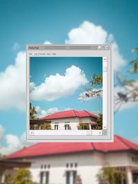 Information sign on building against sky