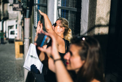 Portrait of people photographing on street in city