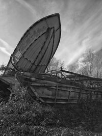 Abandoned boat against sky