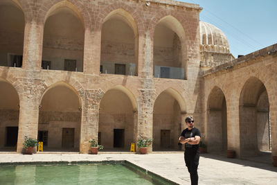 Rear view of man standing in historic building