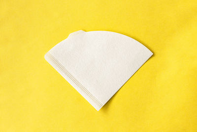 Close-up of paper against yellow background