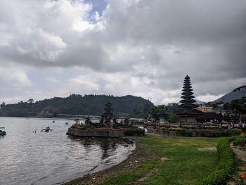 Panoramic view of temple by building against sky