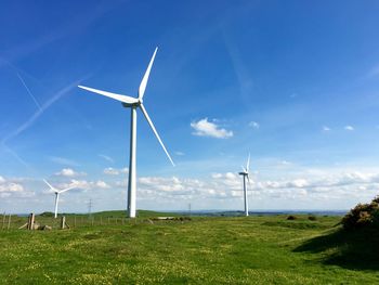 Windmill on field against sky