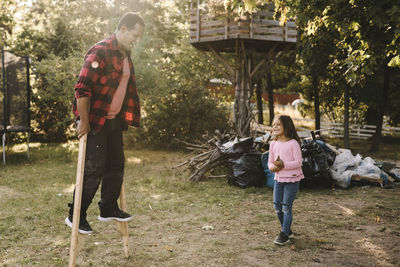 Full length of couple standing against trees