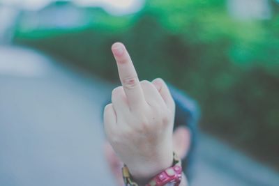 Close-up of person showing middle finger