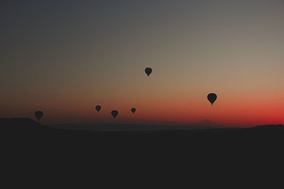 Silhouette of hot air balloon against sky during sunset