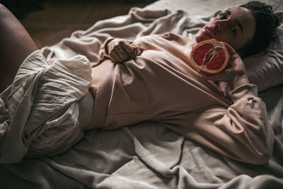 High angle view of woman sleeping on bed at home