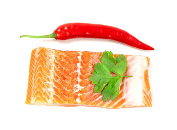 Close-up of red chili peppers against white background