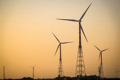 Silhouette of wind turbines at sunset