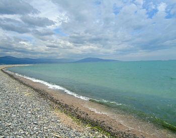 Scenic view of sea against cloudy sky