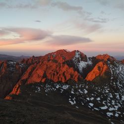 Scenic view of snowcapped mountains against sky during sunset